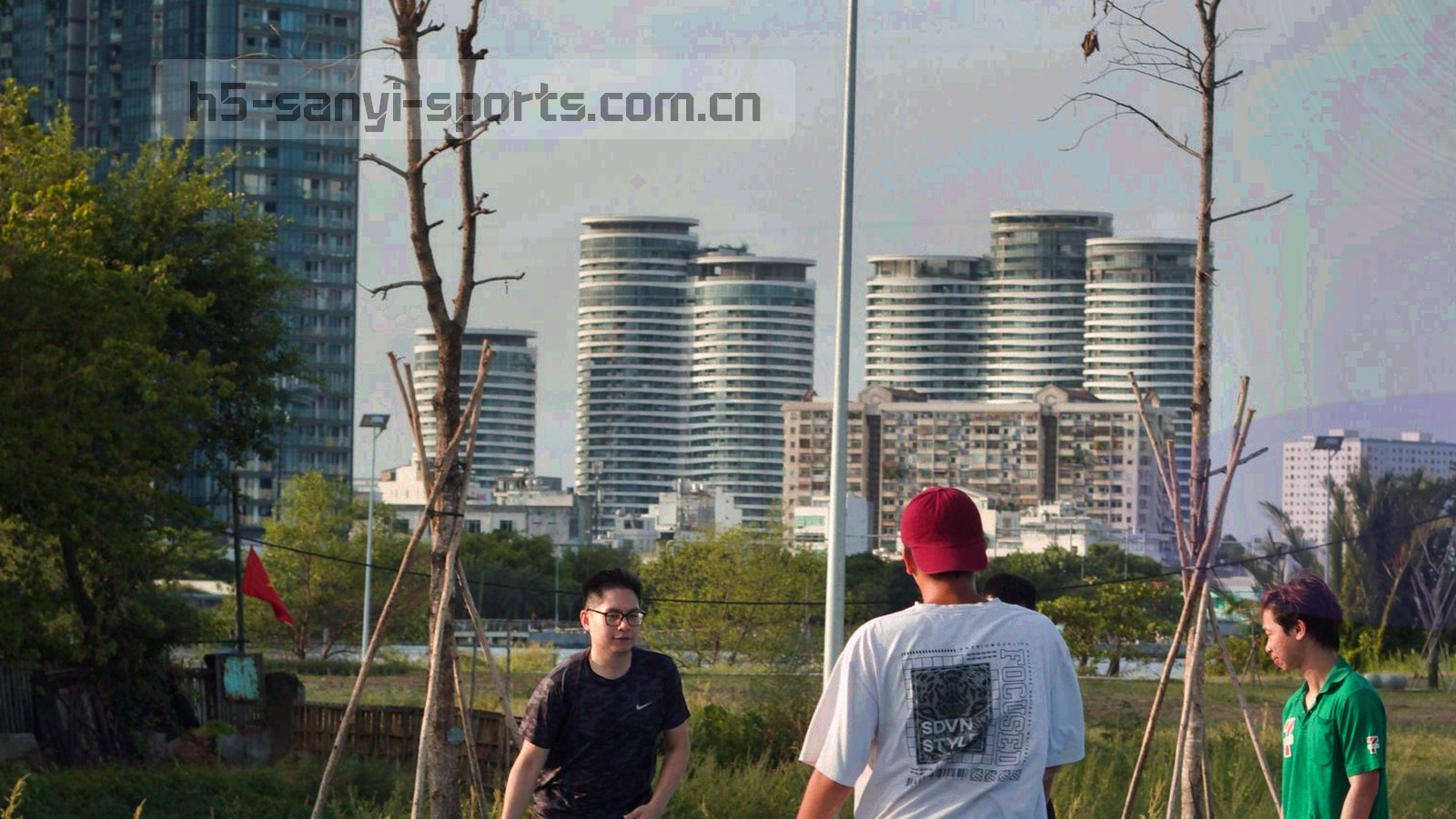 夜场球场俯拍，灯光落在草皮与看台上，画面偏暗、局部高光